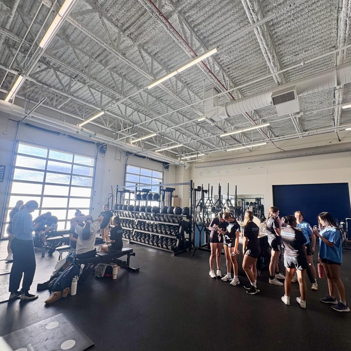 Girls soccer players prepare for a preseason workout in the weight room on Tuesday.